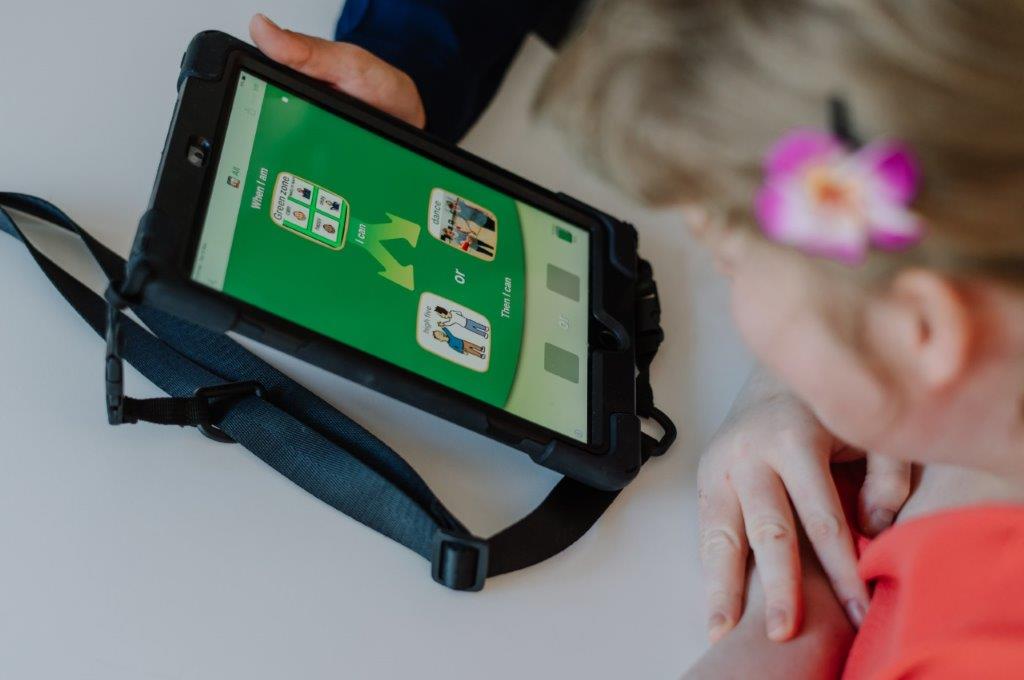 iPad communication device  on table with customer looking in abstract