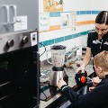 Staff with male student and blender