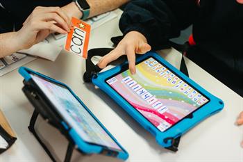 two ipads and hand holding words two ipads and hand holding words